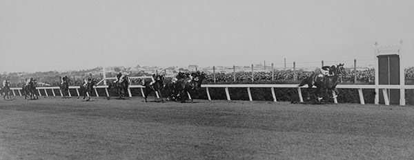 Black and white photograph of a horse race